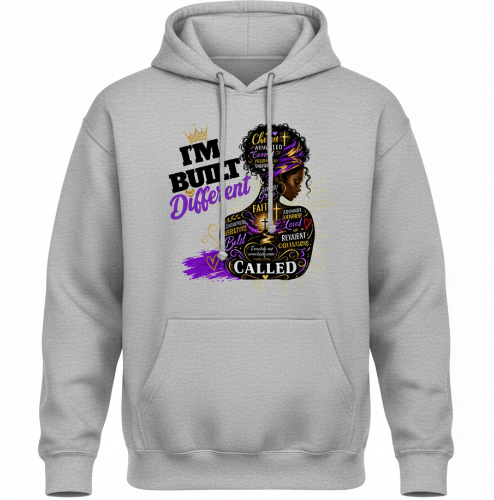 A light gray pullover hoodie with a graphic print on the front. The graphic features a stylized portrait of a Black woman with a purple headband, surrounded by text including 'I'M BUILT Different CALLED' and 'chosen'.
